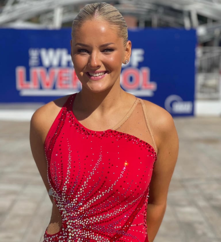 a woman in a red dress with a red dress, also called twirling outfit