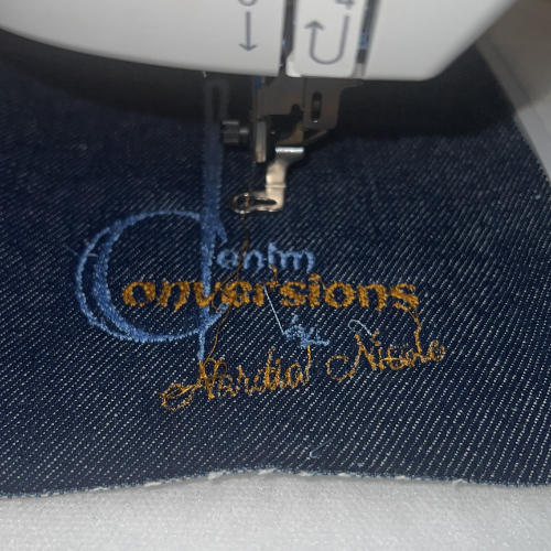 Close-up of stitching, denim texture, denim conversion logo