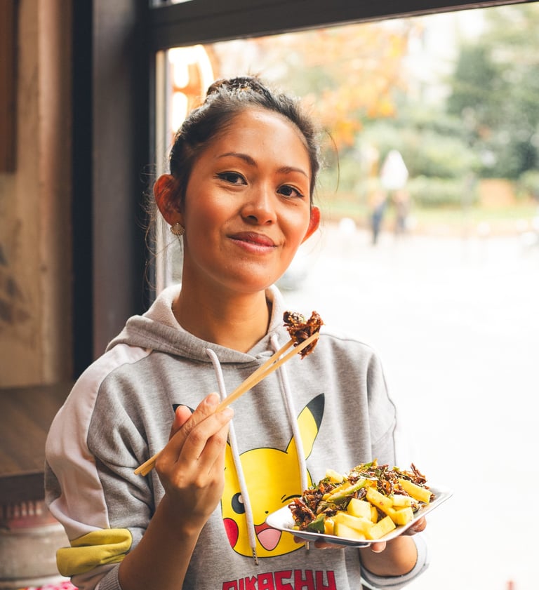 a woman holding a plate with a plate of food