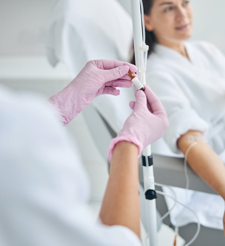nurse giving an iv drip of vitamin to a woman