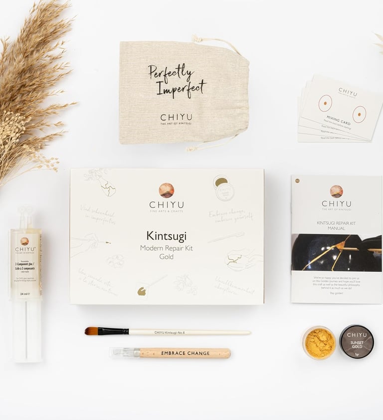 Kintsugi repair kit with gold powder, tools, and manual for mindful ceramic restoration at home.