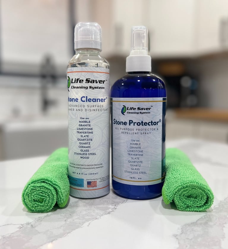 Life Saver Stone Cleaner and Stone Protector bottles with green microfiber cloths on a marble countertop.