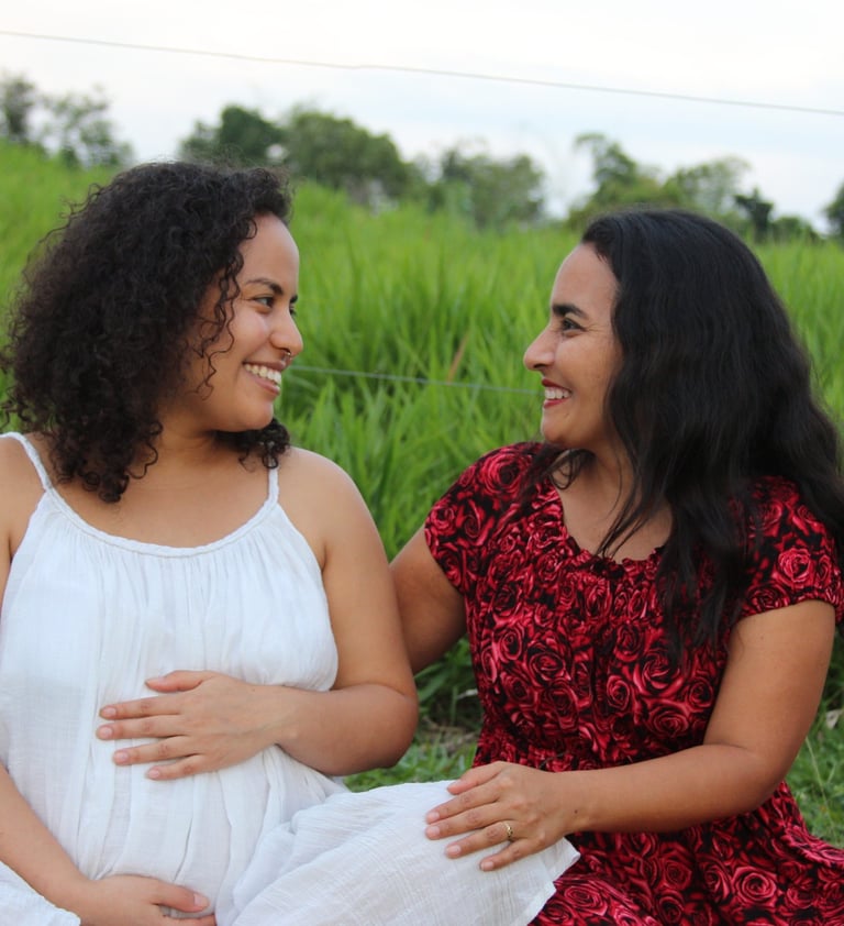 Mother and daughter sitting on a field