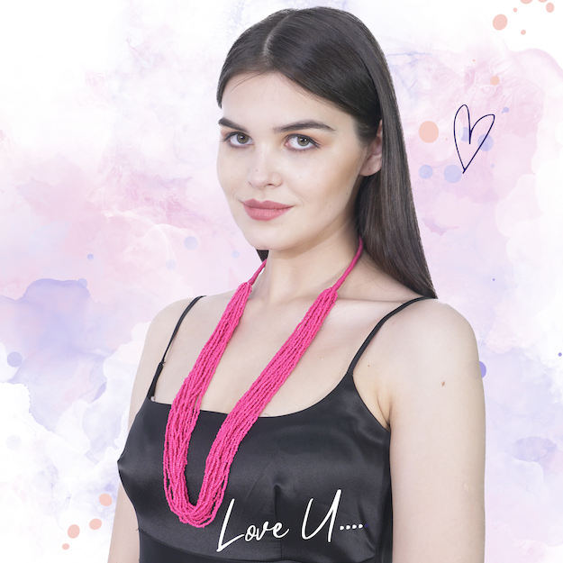 a woman wearing a pink handmade bohemian beaded necklace
