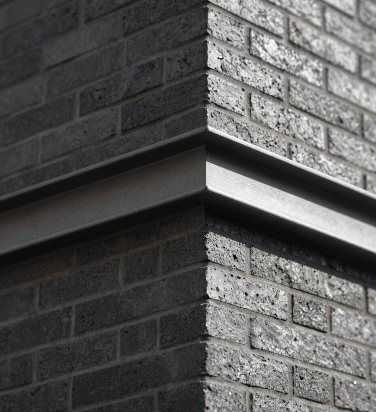 An 'action' shot of a finished architectural detail. A sharp corner of a brick wall meeting a metal beam. Cinematic side lighting creating strong contrast. Touches of #6B705C in the shadows. Editorial style, sharp and clean.
