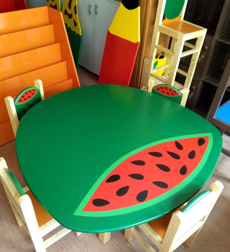 Kids watermelon themed round green table and chair set for a colorful classroom or playroom.