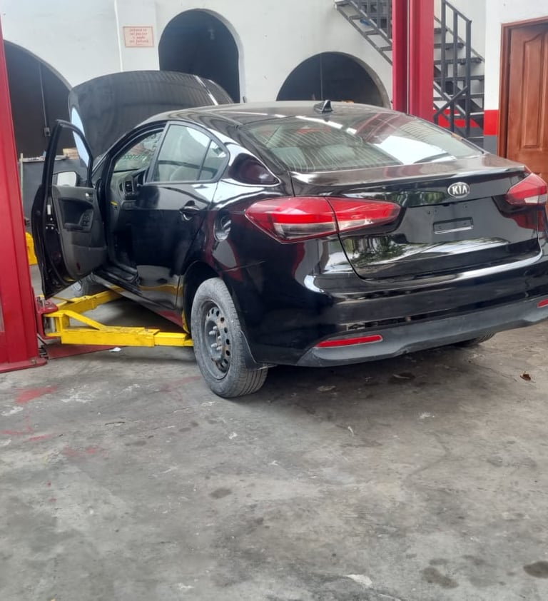 a car in a garage with a car in the background