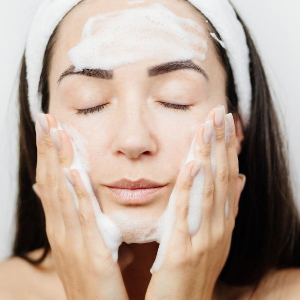 woman cleansing her face
