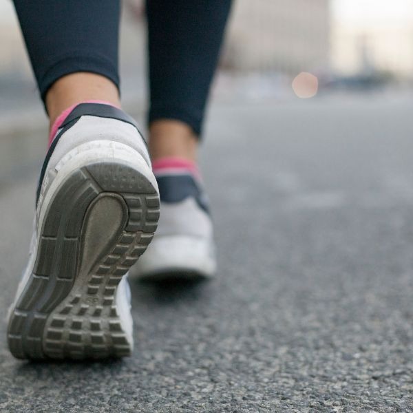 a person walking on a sidewalk 