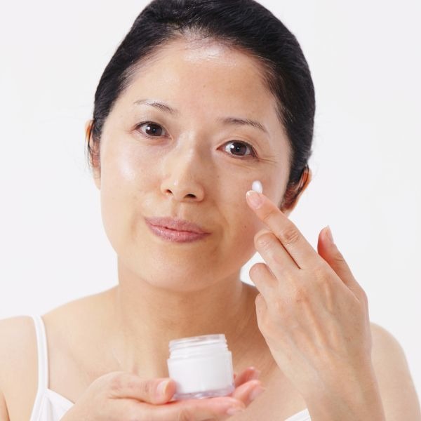 woman moisturizing her face