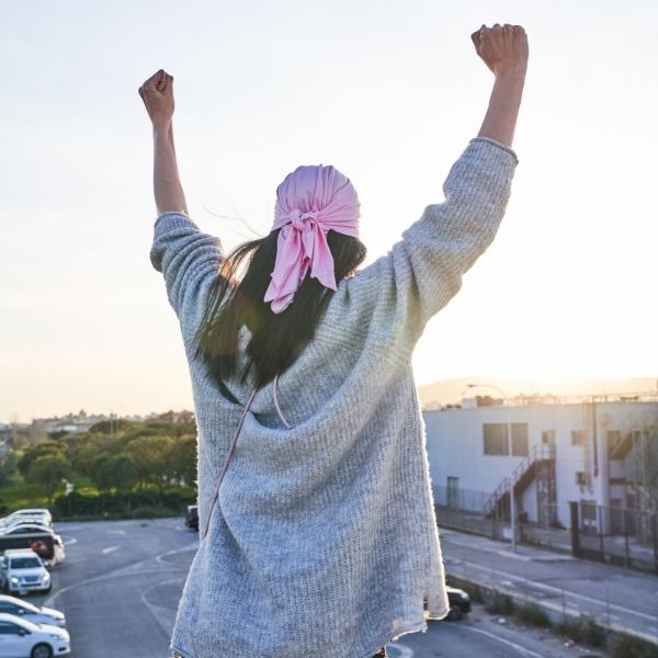 a woman with a pink scarf around her neck
