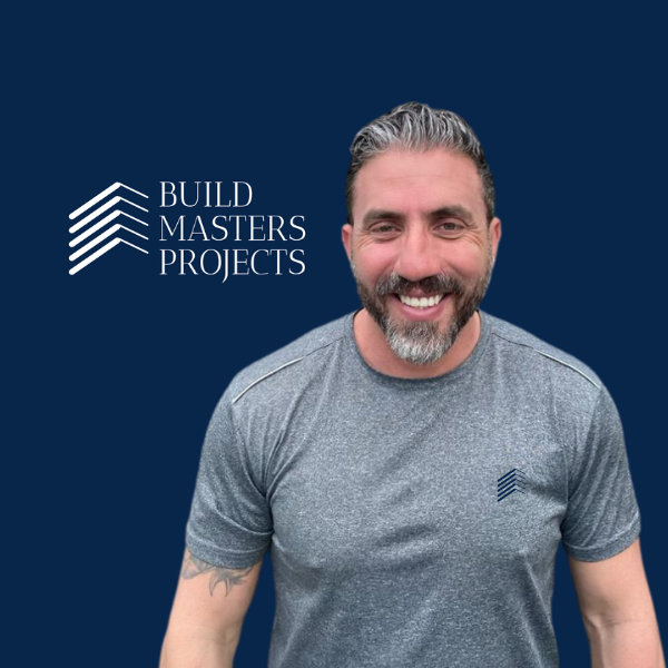 a man with a beard and beard, smiling and wearing a gray shirt