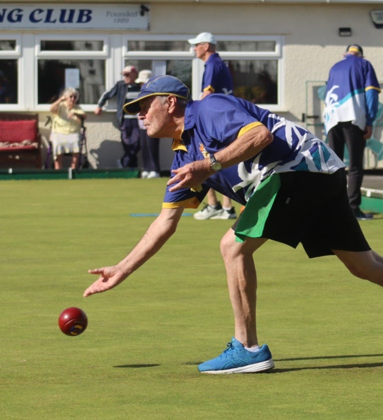 Man bowling on outdoor green
