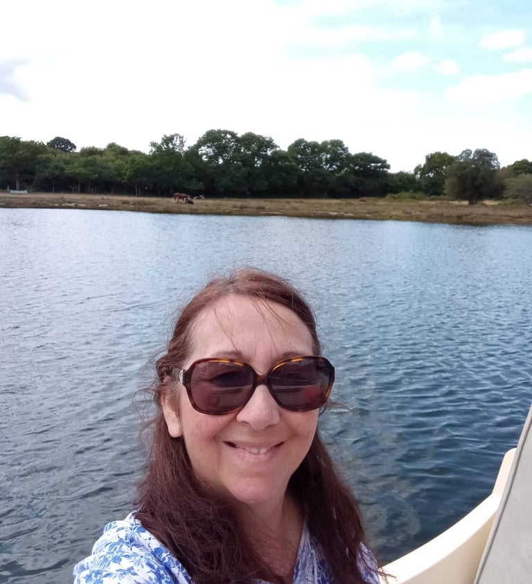 Artist in her boat on the river Beaulie, UK
