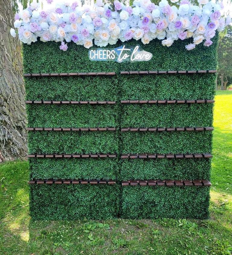 Champagne wall with lavender and white top flower arrangement.