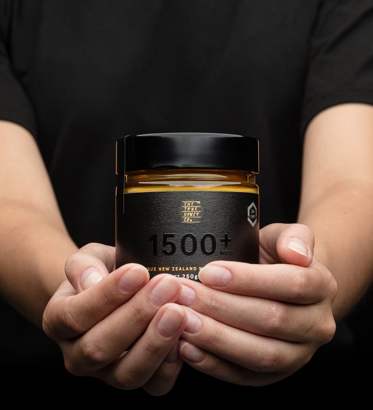 Product photography - a person holding a jar of honey