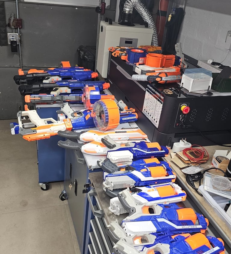 a bunch of nerfet guns are lined up on a table