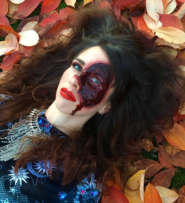 a woman with a bloody face created with special effects makeup