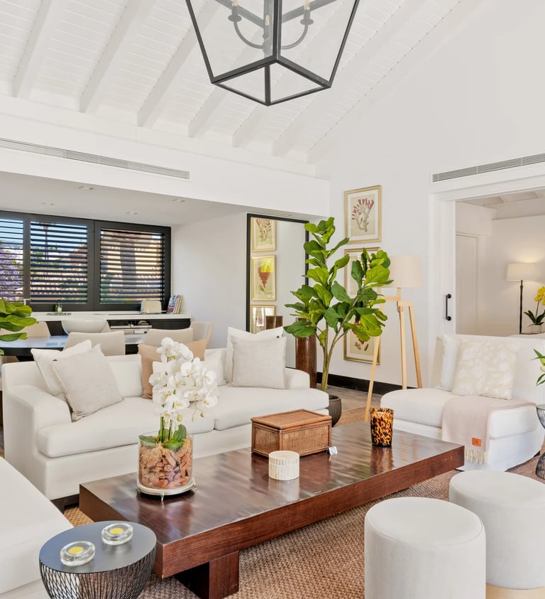 Bright open plan living room with white sofas