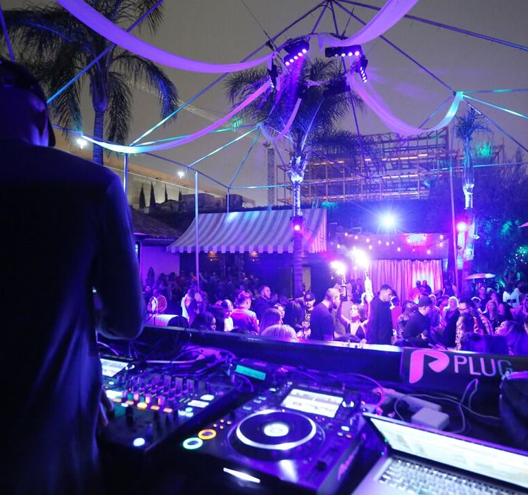 DJ Set with Purple Lights at Outdoor Club with Palm Trees
