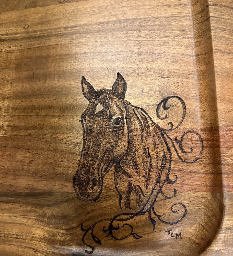 Rustic wood-burned horse head portrait on a handcrafted wooden tray with decorative scrollwork.