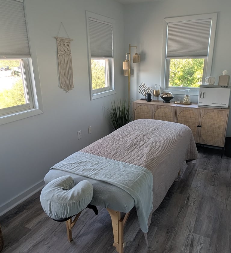a massage studio room with a massage table