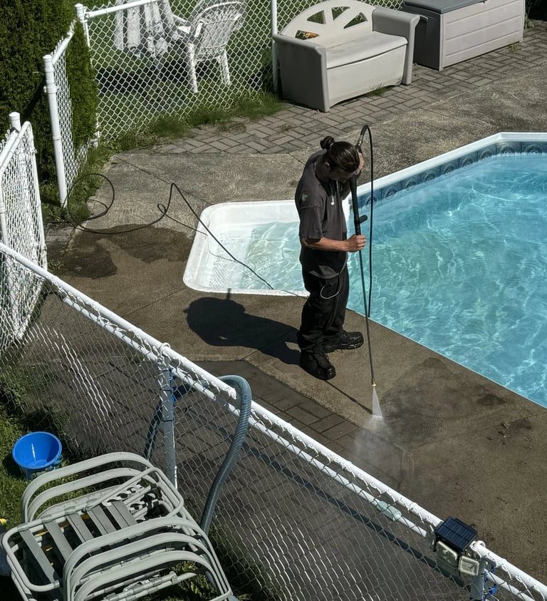 a man is pressure washing a concrete in a backyard