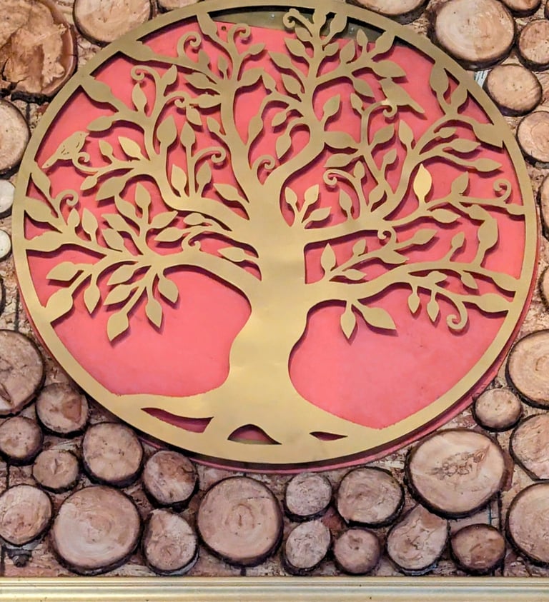 Golden Tree of Life metal wall art decor mounted on a rustic wood log slice background.