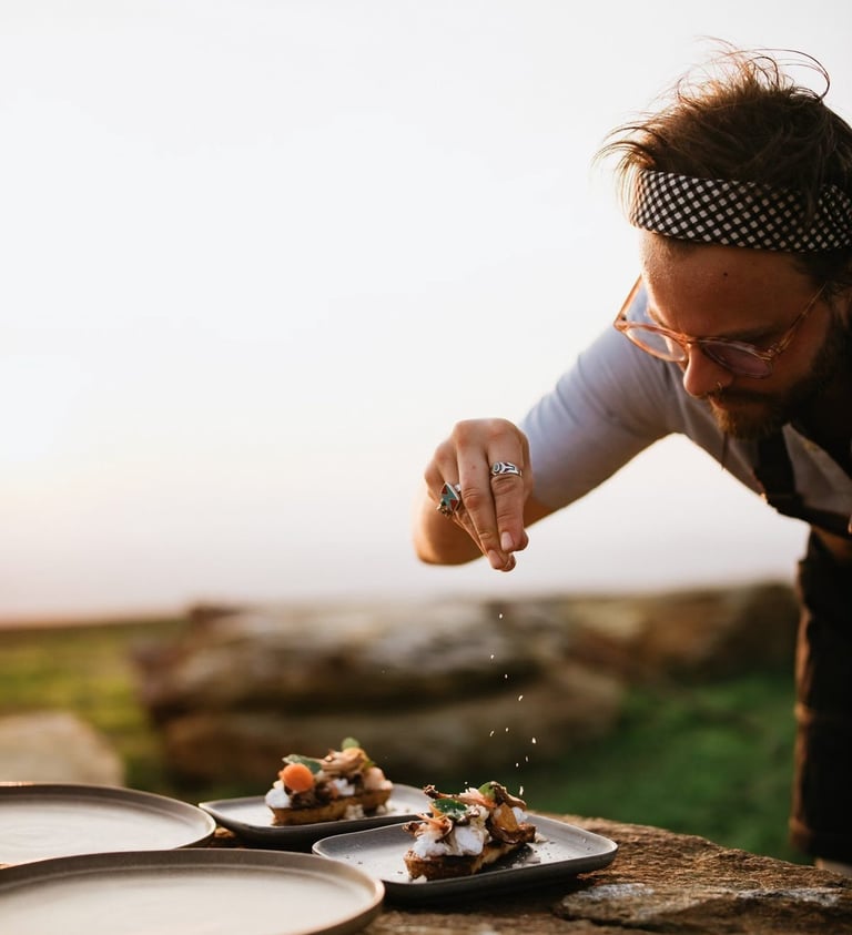 a man is sprinkling food on a table