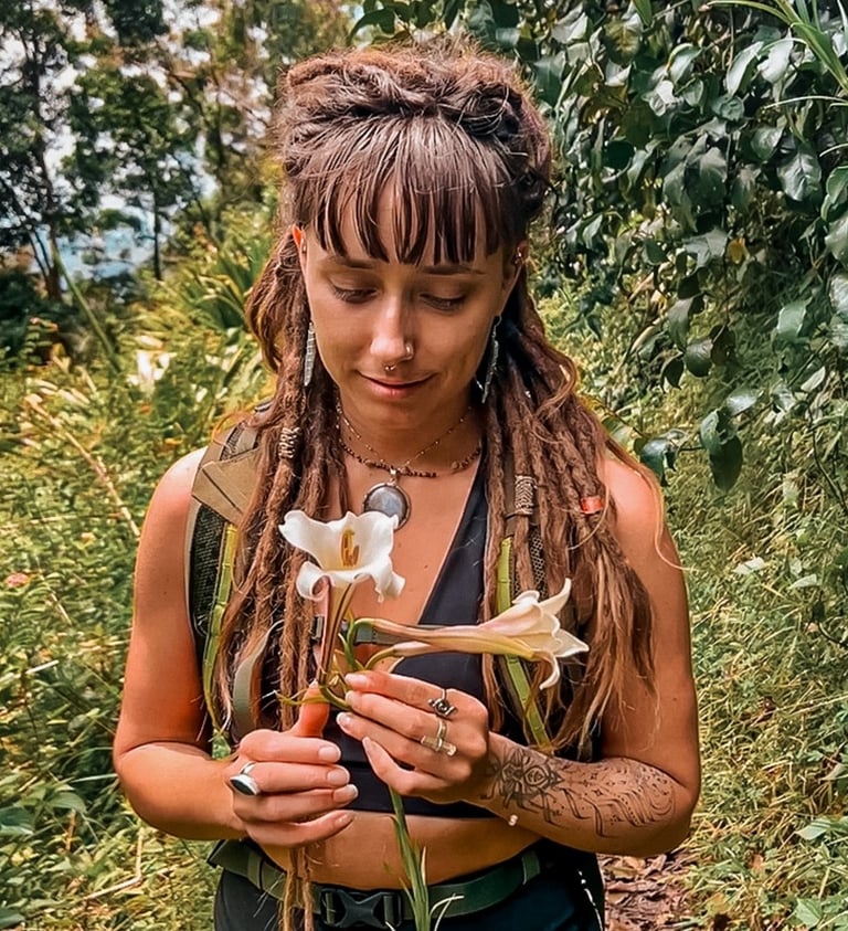 a woman with dreadlocks and dreadlocks holding a flower