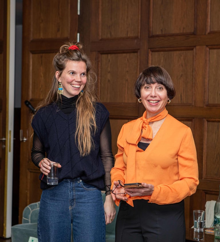 Two confident women, smiling and having fun teaching a seminar for women on public speaking. 