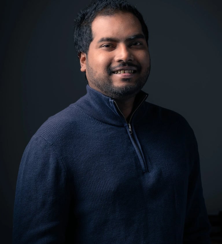 a man in a blue sweater in a dark background