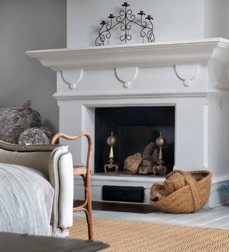 Fireplace with baskets and decor at Finca Santa Katerina