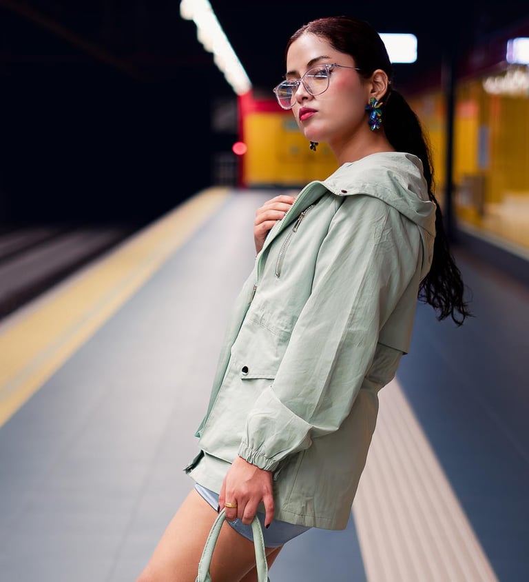 Rashell Campos, mujer hermosa posando con una falda chaqueta verde y cartera en el metro Quito
