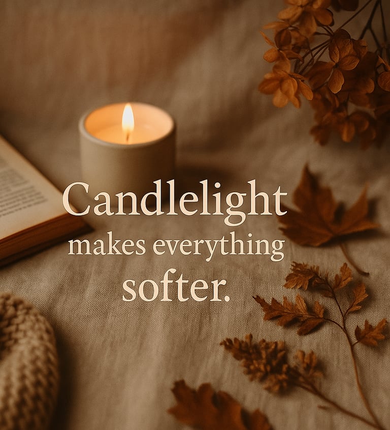 Candlelit fall flat-lay with an open book, knit blanket, and dried leaves
