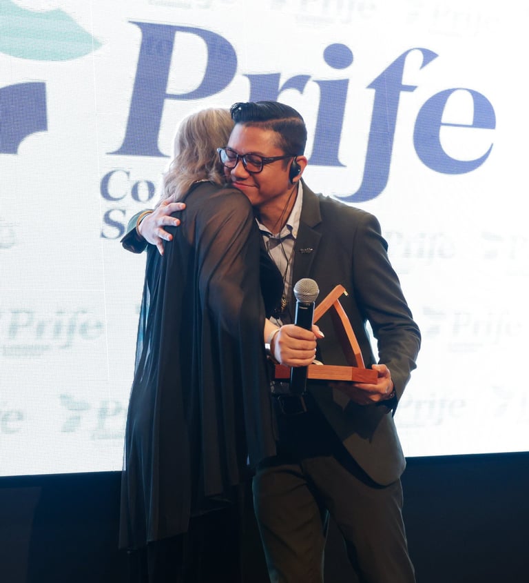 a man in a suit and tie is giving a hug