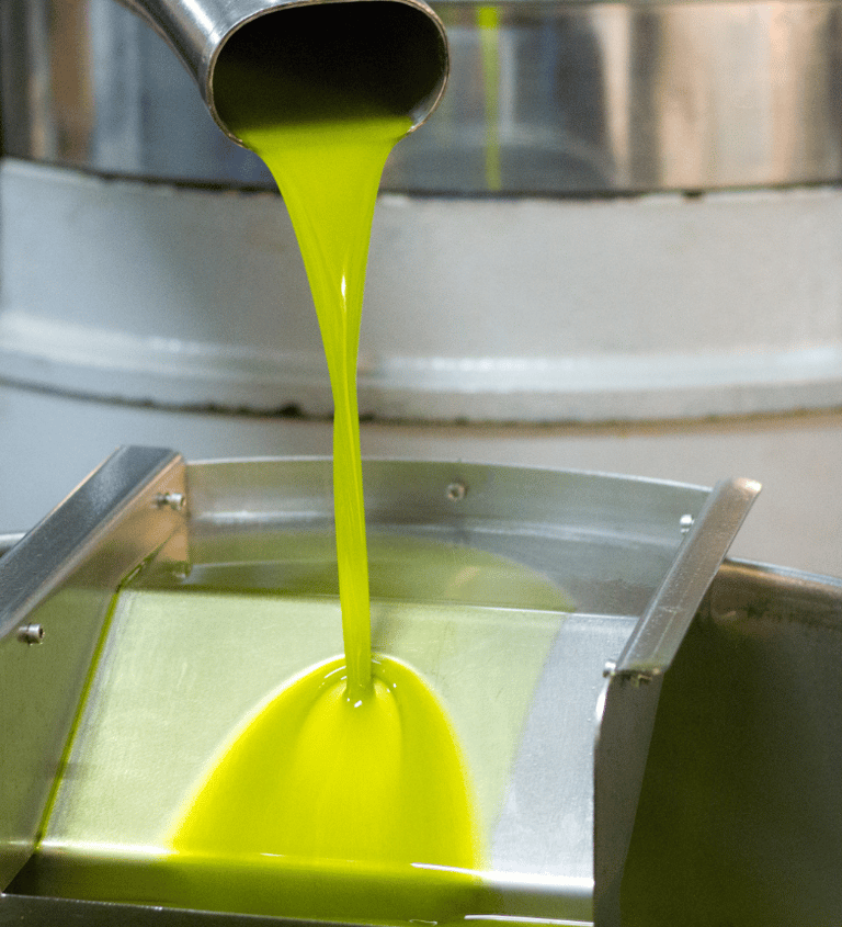 a yellow liquid pouring into a bucket of liquid