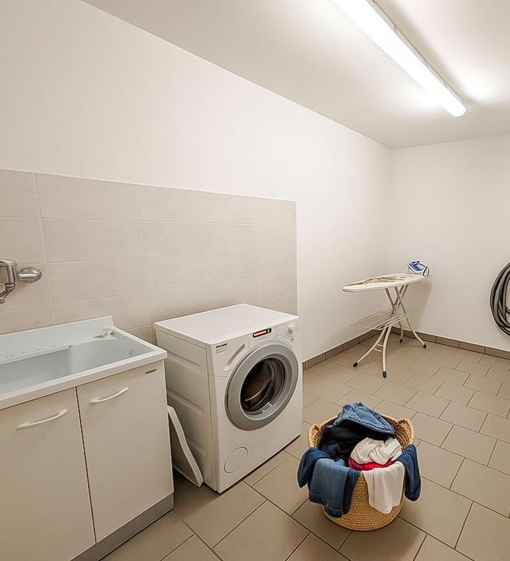 a laundry room with a washing machine and a laundry basket