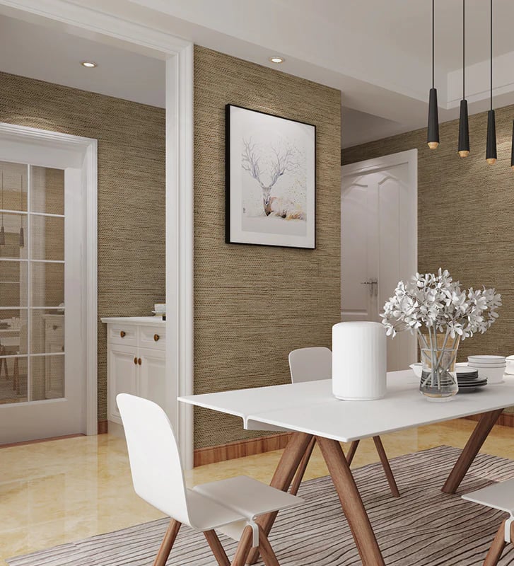 Modern dining room with brown textured wallpaper, white table, and black pendant lights.