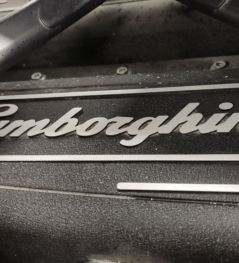 an Enlab close up of a Lamborghini engine with a nameplate on it