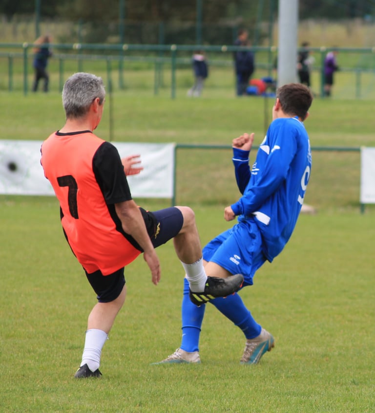 2 adultes jouant au foot