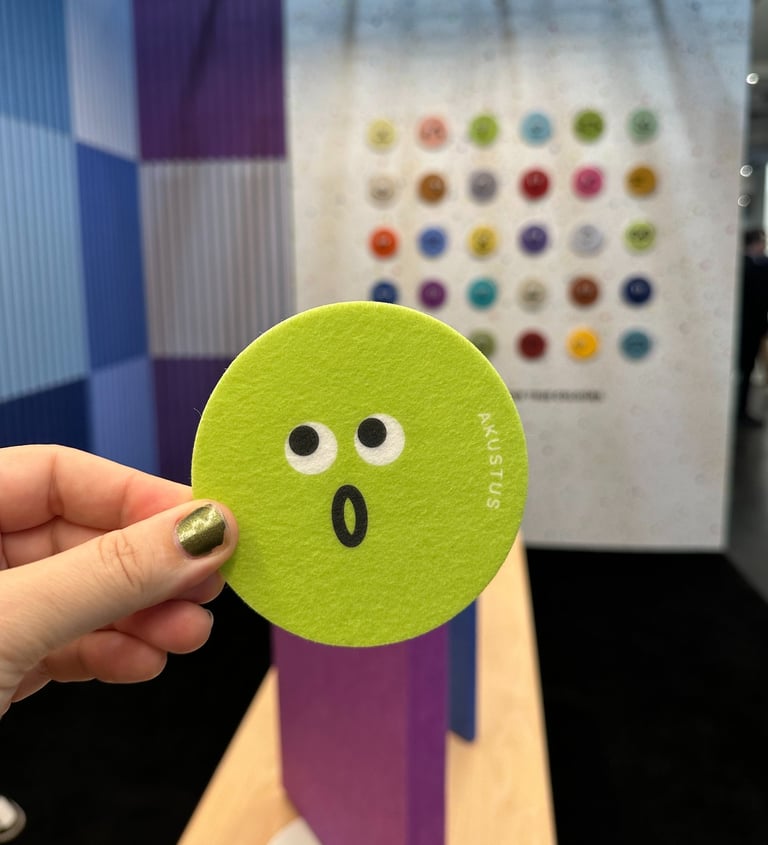 cute emoji face in front of multicolored acoustic wall