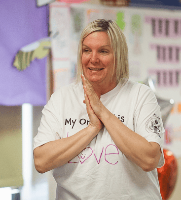 NaliniKIDS program teacher smiles.