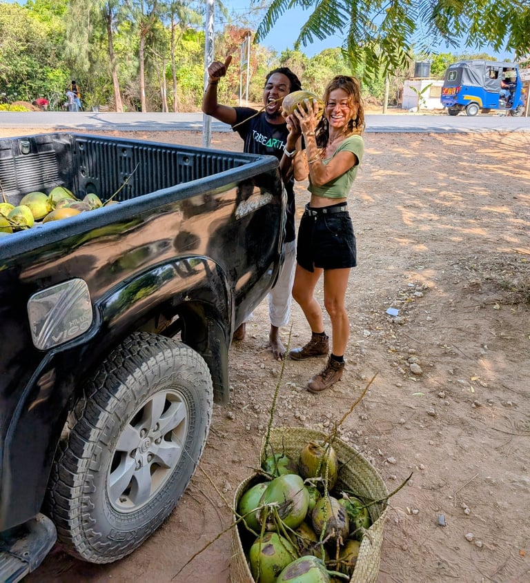 happy customers receive fresh harvested coconuts from the aak farm
