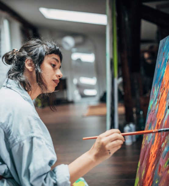 A female artist working on a painting