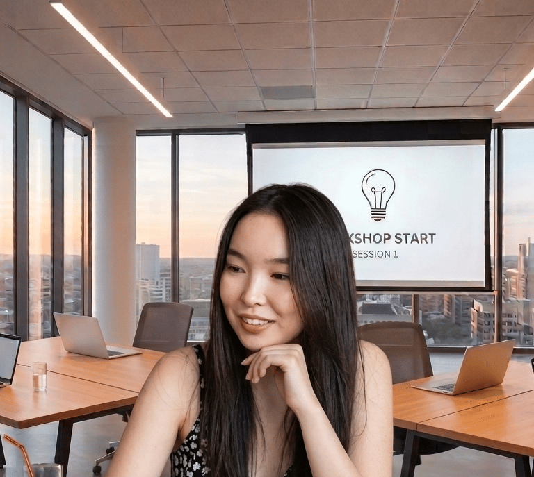 Smiling woman attending a corporate workshop in a modern office with laptops and city views.