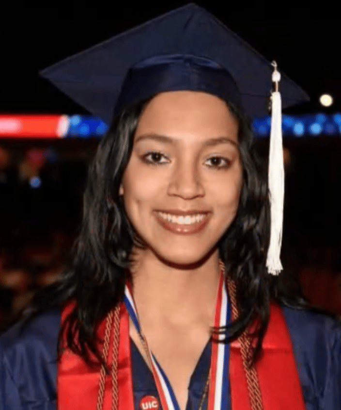 Headshot picture of Taylor guy in a graduation cap and gown.