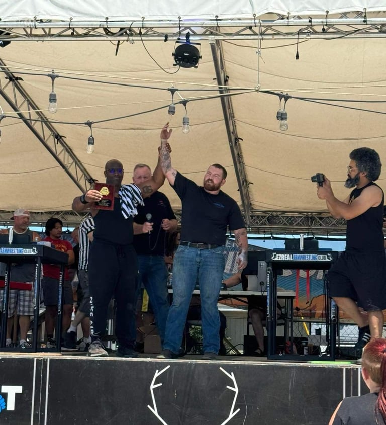 Champion arm wrestler raises his arm in victory 