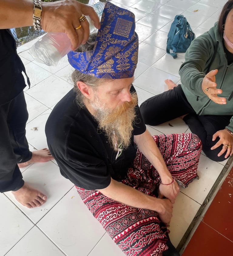 a man sitting on a white tile floor undertaking a ceremony