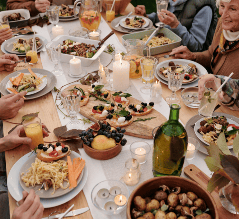 A group dinner with the image focused mostly on the plates of food